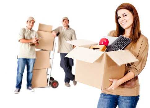 Professional movers handling boxes and furniture for a home relocation