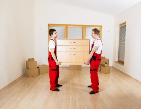 Packed boxes and furniture ready for loading into a moving van